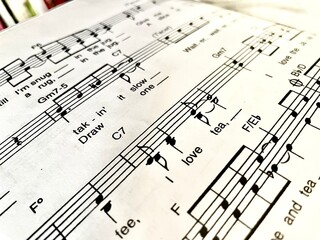 music sheet music background with lyrics about coffee and tea
