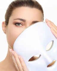 Beauty and skincare treatment featuring photon therapy light mask for skin rejuvenation with a...