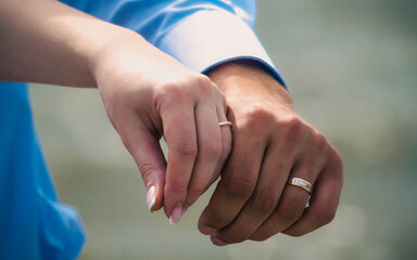 hands of married man and woman with rings