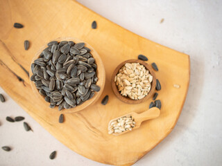 Sunflower seeds in a wooden bowl and scoop.