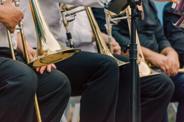 ands and trumpets of symphony orchestra musicians close up