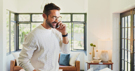 Fototapeta premium Home, phone call and man in lounge, conversation and communication with connection. Apartment, person and guy with smartphone, mobile user and happiness with network, chatting or smile in living room