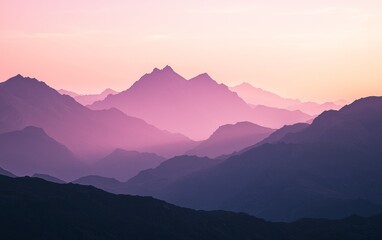Obraz premium Sunset lights up mountain peaks with soft hues during twilight