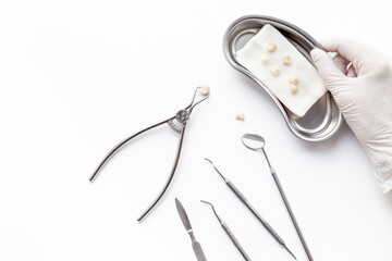 Dental steel instruments for dental prosthetics and oral treatment on a white background. Dentist...