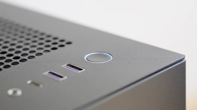 Computer in sleep mode. Flashing light around the power button. Close up