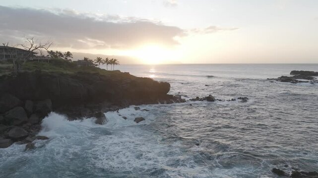 Static shot showcasing the coastline and sunlight in the background.