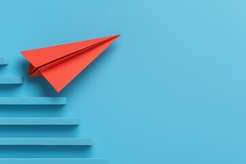 Vivid Red Paper Airplane Climbing Blue Paper Stairs on a Blue Background Concept For Growth and Success