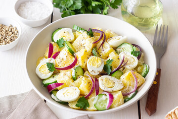 Salad with potatoes, cucumber, onion and eggs. Healthy food. Vegetarian food.