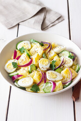 Salad with potatoes, cucumber, onion and eggs. Healthy food. Vegetarian food.