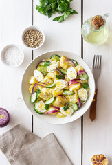 Salad with potatoes, cucumber, onion and eggs. Healthy food. Vegetarian food.