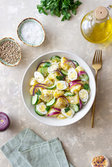 Salad with potatoes, cucumber, onion and eggs. Healthy food. Vegetarian food.