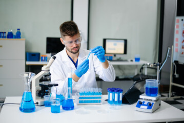 Fototapeta premium scientists in lab coats conducting research, handling glassware, and working with chemicals