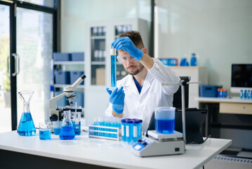 male scientist working with micro pipettes analyzing biochemical samples, advanced science chemical...