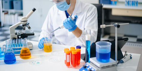 Fototapeta premium scientists in lab coats conducting research, handling glassware, and working with chemicals