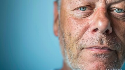 Obraz premium Reflective portrait of mature man with thoughtful expression against blue background