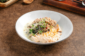 Portion of healthy quinoa dish with creamy chicken breast