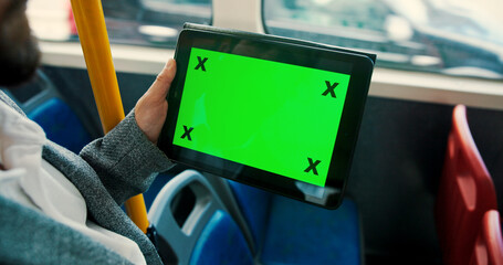 Hand, tablet and green screen in bus, travel and user experience with tracking markers on commute. Person, digital touchscreen and ui display on app, mock up space and contact on public transport
