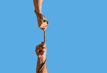 Rescue, help, helping gesture or hands. Two hands, helping hand, arm, friendship. Hand hold in rope connecting for concept teamwork. Hand holding a rope, climbing rope © Yevhen