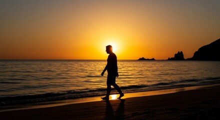 Man Walking on Beach at Sunset
