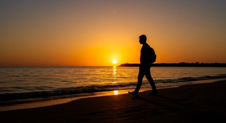 Fototapeta premium Man Walking at Sunset Beach