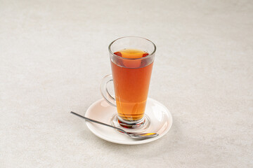 Glass mug of hot black tea
