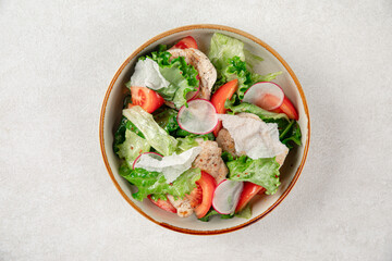 Portion of fresh vegetables salad with chicken
