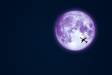 Full Worm blue Moon and silhouette airplane flight on night sky