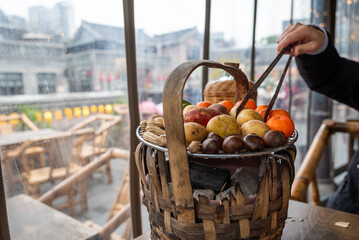 A Beautiful Colorful Fruit Basket Displayed on a Cozy Cafe Table for Guests to Enjoy