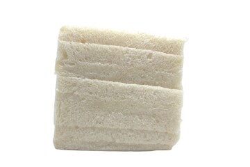 White bread stacked on a plain white background. The bread is square in shape, soft and fluffy in texture, and has a light cream color.