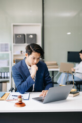 Asian man lawyer working and gavel, tablet, laptop in front, Advice justice and law concept...