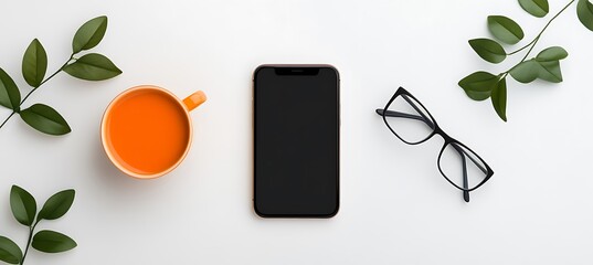 Overhead view of an arrangement with phone coffee and leaves