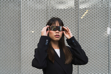 Asian businessoman wearing cyberglasses in a futuristic suit