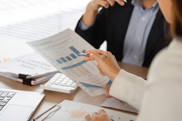 Business Meeting and Data Analysis. Professionals collaborating on financial reports during a meeting.