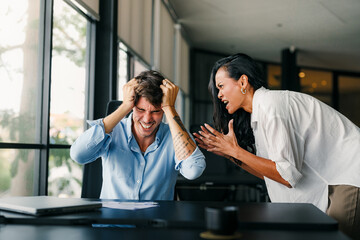 Workplace aggression, stressful work environment. Angry boss shouting at the worker in the office