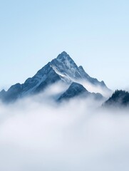 Landscape photograph of a mountain peak covered in fog. the mountain is in the center of the image, with a clear blue sky in the background. the peak is covered in snow and has a jagged, jagged edge.