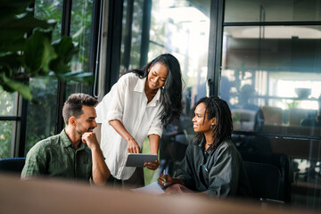 Team of industrial design agency specialists, software engineer programmers discussing in office