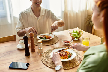Young couple enjoying a cozy meal together in their charming home during a sunny afternoon