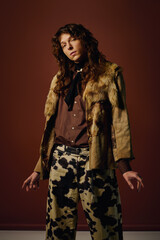 A young man showcases his unique fashion sense with flair in a creative environment