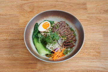 Noodles with sliced meat and vegetables. Delicious freshly prepared meal, perfect for menus, restaurants, or food delivery concepts.