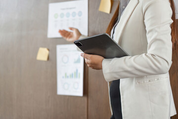 Business Communication and Strategy. A woman presents key performance indicators in a project...