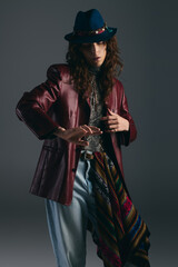 Fototapeta premium Stylish young man showcasing artistic fashion in a modern studio setting