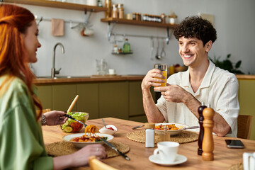Young couple enjoying a joyful meal together in their cozy kitchen on a beautiful afternoon
