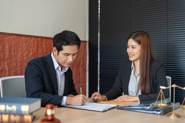Client Consultation and Document Preparation. A lawyer collaborating with a client on important legal matters in her office.
