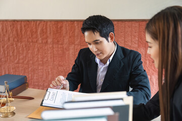 Contract Signing and Legal Expertise. A client focusing on important legal agreements with guidance from a lawyer.