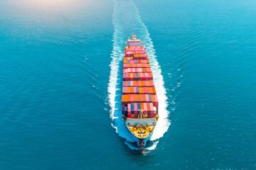 Giant container ship heavy ship goes on water with a lot of cargo in the sea strait when entering...