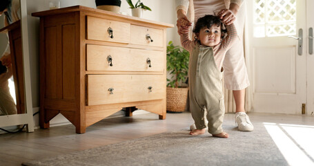 Parent, baby and holding hands for learning to walk with first steps, mobility support or child development. Milestone, person or helping toddler with teaching balance, coordination or growth in home