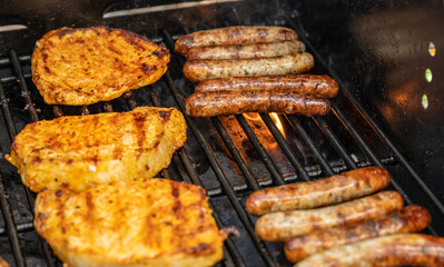 Barbecue grill bbq on propane gas grill steaks bratwurst sausages meat meal