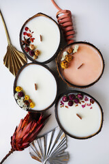 Handmade eco-friendly coconut shell candle with natural soy wax, a wooden wick, and a tropical aroma, perfect for a cozy, sustainable, and relaxing ambiance