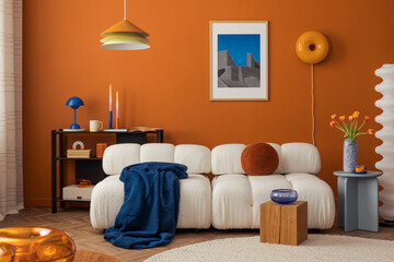 Modern cozy living room with white boucle sofa, orange wall and eclectic decor in bold colors...