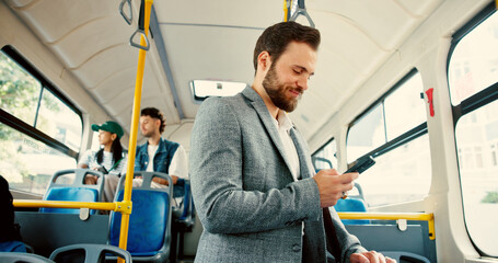Business, man and travel on bus with phone for transport schedule, checking notifications and morning commute. Happy, passenger and smartphone on journey for text message, social media and connection